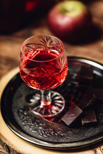 Homemade berry alcoholic beverage and chocolate Homemade berry alcoholic beverage and chocolate bars on metal tray nalewka stock pictures, royalty-free photos & images