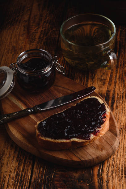 istock Toast with berry jam and green tea 1157846739