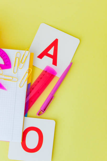 istock Back to school concept with space for text. Top view. Copy space. School office supplies.Creative desk with colourful stationery. Colored paper clip.School supplies on yellow background.Office desk 1157852373