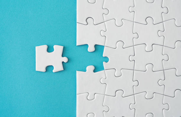 istock White Jigsaw Puzzle Pieces On Blue Background 1157853718