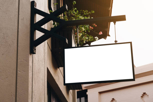 istock Empty signage and blank mock up hanging on street with copy space 1157854536