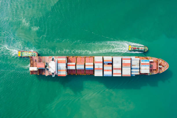 istock Aerial view and top view. Container ship in pier with crane bridge carries out export  and import business in the open sea. Logistics and transportation 1157854821