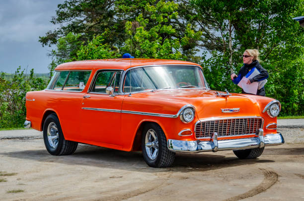 Chester, Nova Scotia, Canada - June 22, 2019 : 1955 Chevy Nomad at annual Graves Island Car Show at Graves Island Provincial Park, Chester, Nova Scotia Canada. An attendant greets the driver with directions on where to park