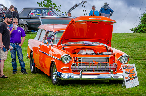 Chester, Nova Scotia, Canada - June 22, 2019 : 1955 Chevy Nomad at annual Graves Island Car Show at Graves Island Provincial Park, Chester, Nova Scotia Canada. Two men stand near the Chevy.