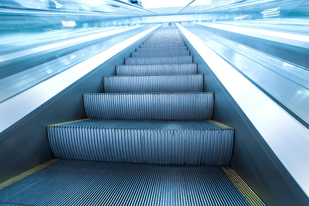 istock steps of escalator in business center 115785821