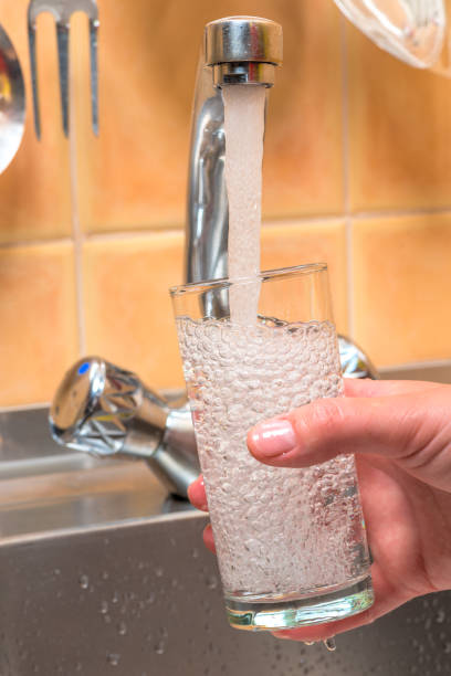 istock clean drinking water is poured from the kitchen tap into the glass 1157858549