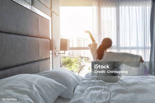 Hotel Room Comfort With Good Sleep Easy Relaxation Lifestyle Of Asian Girl On Bed Have A Nice Day Morning Waking Up Taking Some Rest Lazily Relaxing In Guest Bedroom In City Hotel Stock Photo - Download Image Now