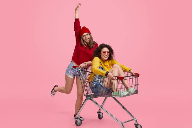istock Friends having fun with shopping cart 1157859957