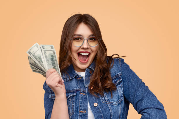 istock Excited woman with money 1157860005