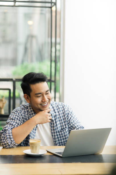 istock Smart Asian man working with laptop in cafe, work concept and copy space. 1157877263