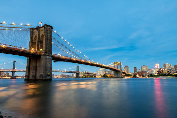 istock Low angle View of the Brooklyn Bridge At night 1157878503