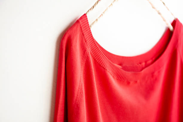 istock a cut sew or knit in red hanging on clothes hanger on white background. 1157879685