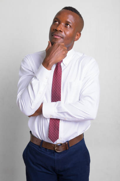 istock Young African businessman thinking and looking up 1157880432