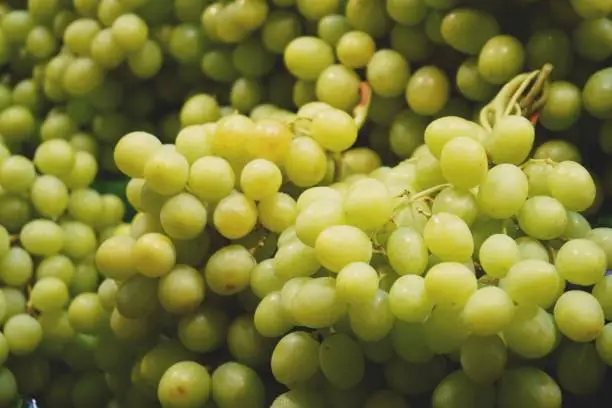 Photo of pile of grape on a market background close up
