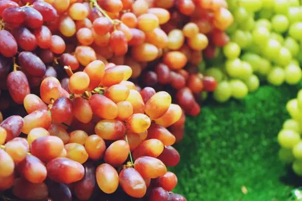 Photo of pile of grape on a market background close up