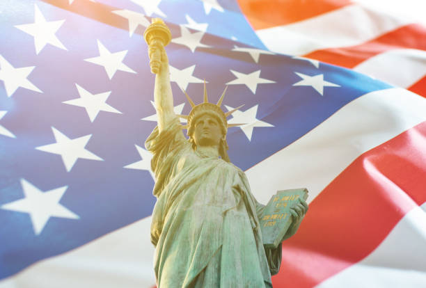 istock Statue of liberty with American flag double exposure 1157882787