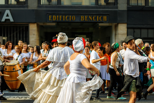 Buenos Aires, Argentina - March 24, 2019: Two women in colonial costumes dance in a demonstration in repudiation of the last Argentine military dictatorship