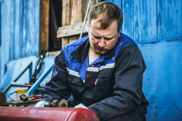 istock Iron workers saw sparks worker sawing the iron 1157887116