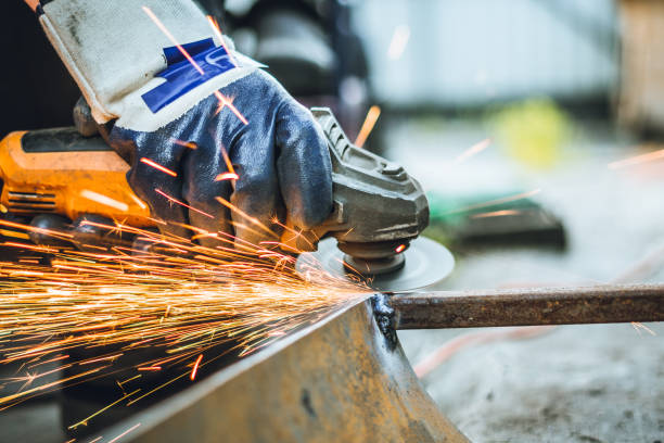 istock Iron workers saw sparks worker sawing the iron 1157887151