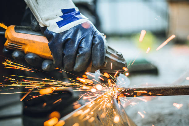 istock Iron workers saw sparks worker sawing the iron 1157887292