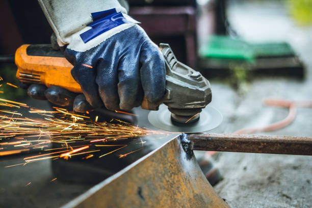 istock Iron workers saw sparks worker sawing the iron 1157887521