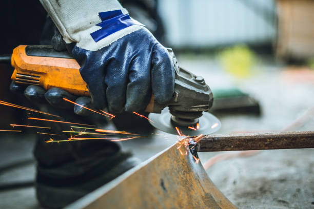 istock Iron workers saw sparks worker sawing the iron 1157887537