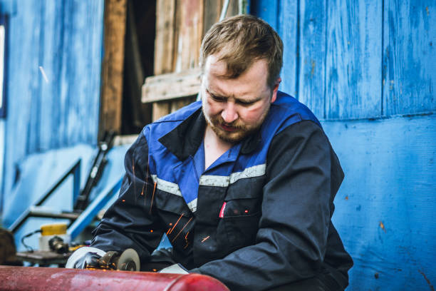 istock Iron workers saw sparks worker sawing the iron 1157887572