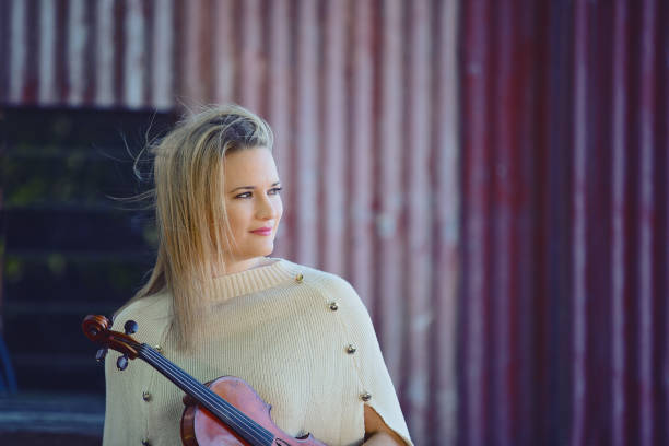 istock Beautiful Woman Holding Rare Violin 1157887603