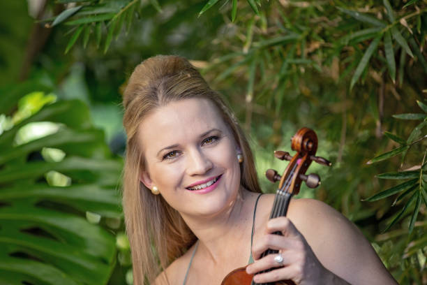 istock Female Musician Holding Vintage Violin 1157887607