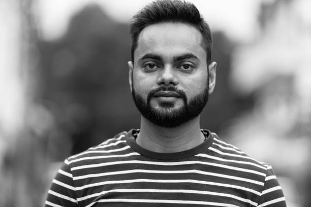 istock Young bearded Indian man outdoors in black and white 1157889711