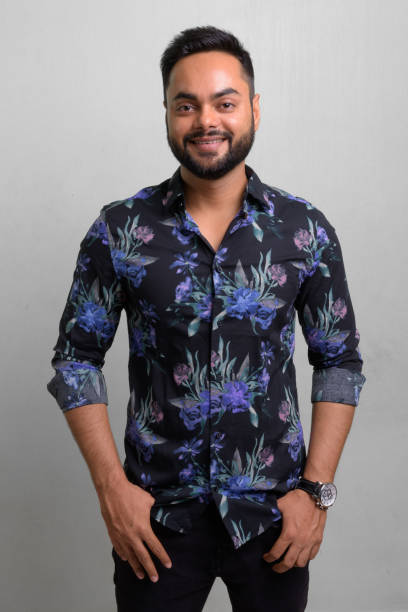 istock Young bearded Indian man against white background 1157889851
