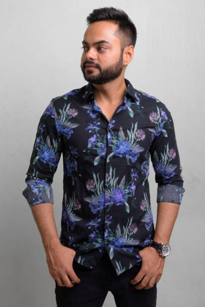 istock Young bearded Indian man against white background 1157889924