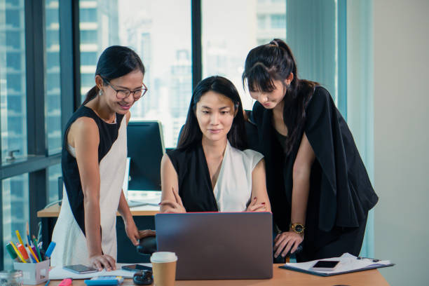 istock working women woking together in office 1157893663