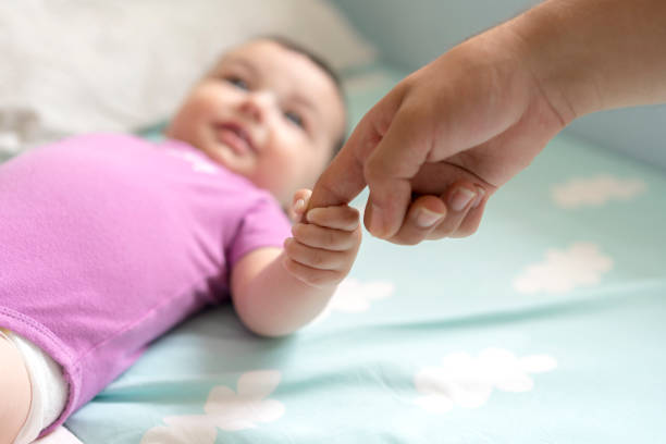 istock Cute baby boy lying in bed 1157894984