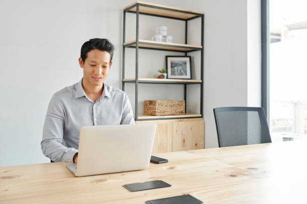 istock Positive businessman working on laptop 1157895090