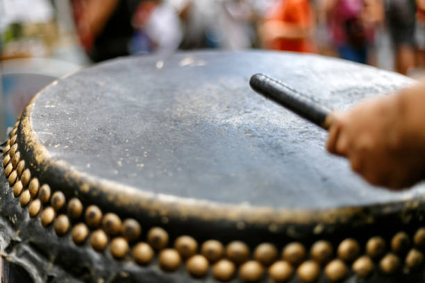 istock Close-up macro of a drumhead while hands hit it 1157895187