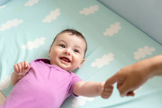 istock Cute baby boy lying in bed 1157895195