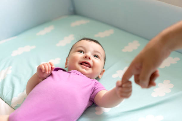 istock Cute baby boy lying in bed 1157895221