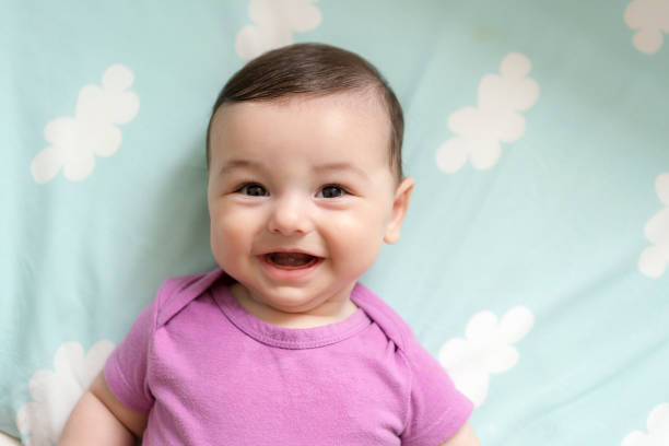 istock Cute baby boy lying in bed 1157895270