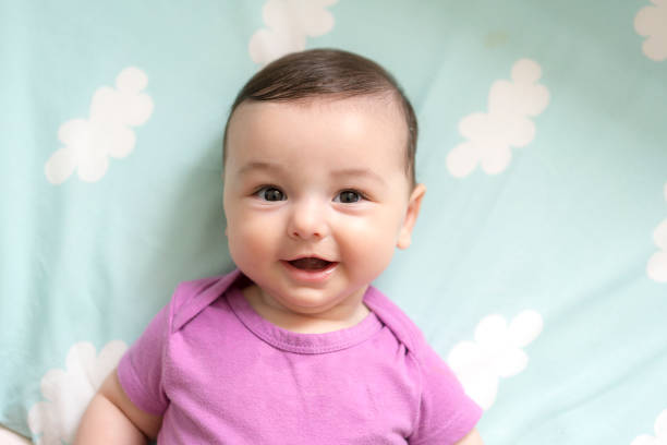 Cute baby boy lying in bed