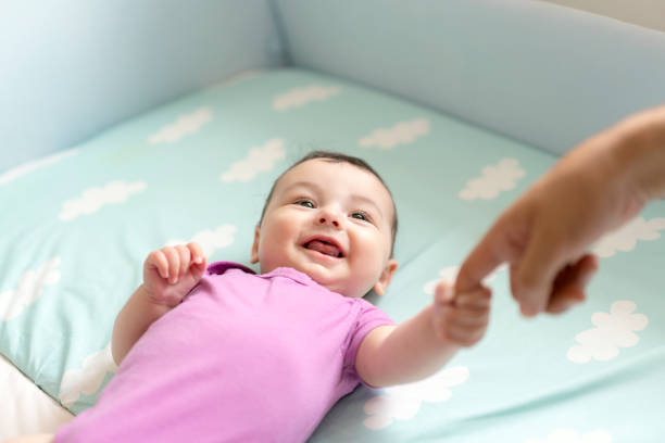 istock Cute baby boy lying in bed 1157895357
