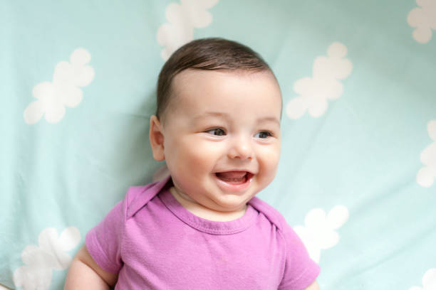 istock Cute baby boy lying in bed 1157895358