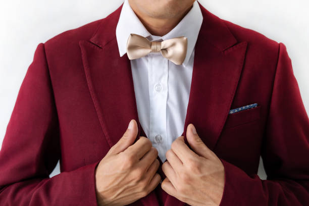 istock Young man wearing red suit with bow tie 1157896046