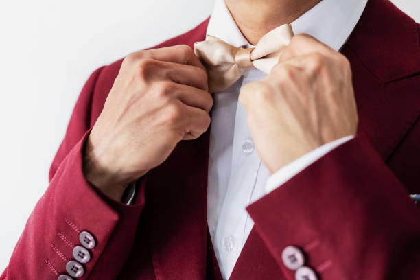 istock Young man wearing red suit with bow tie 1157896050