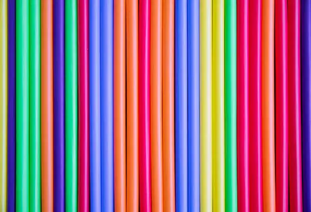 Close up view of a row of colorful plastic straws