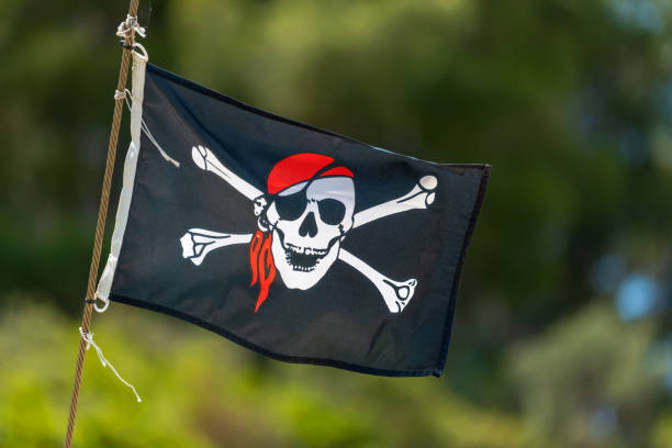 istock Waving in the wind pirate flag on the mast 1157899033