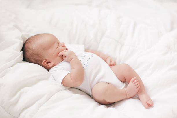 istock newborn baby lying on a white blanket 1157899232