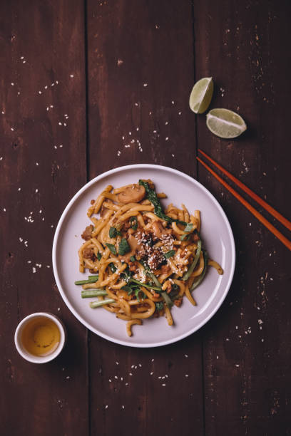 istock Fried udon with vegetables on wooden table 1157900482