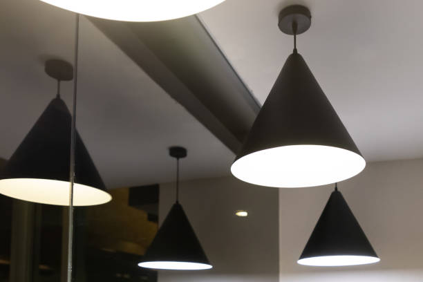 istock black hanging lamp on ceiling near glass window at night time. 1157901293
