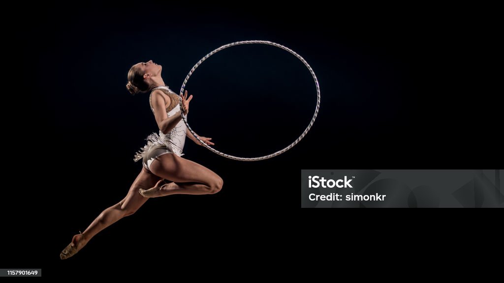 Gymnast Doing Rhythmic Gymnastics With Hoop Stock Photo - Download Image  Now - Plastic Hoop, Gymnastics, Rhythmic Gymnastics - iStock